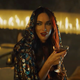 A vampiric Megan Fox sups at her drink in a scene from Night Teeth.